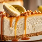 Slice of banana cheesecake with caramel drizzle and banana slices