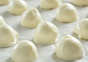 Cheesecake filling portions laid out on parchment paper